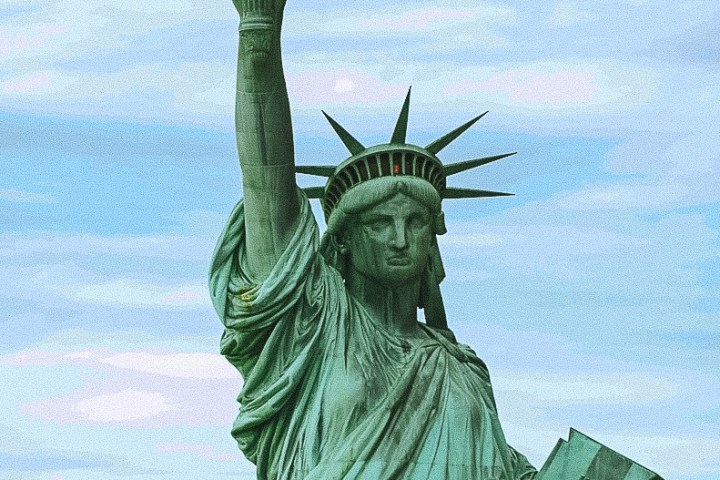 Statue of Liberty close-up against a cloudy sky.