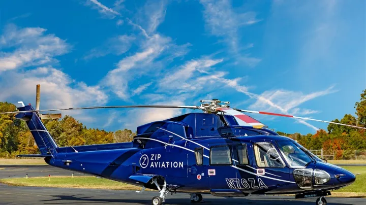 a small blue plane sitting on top of a runway
