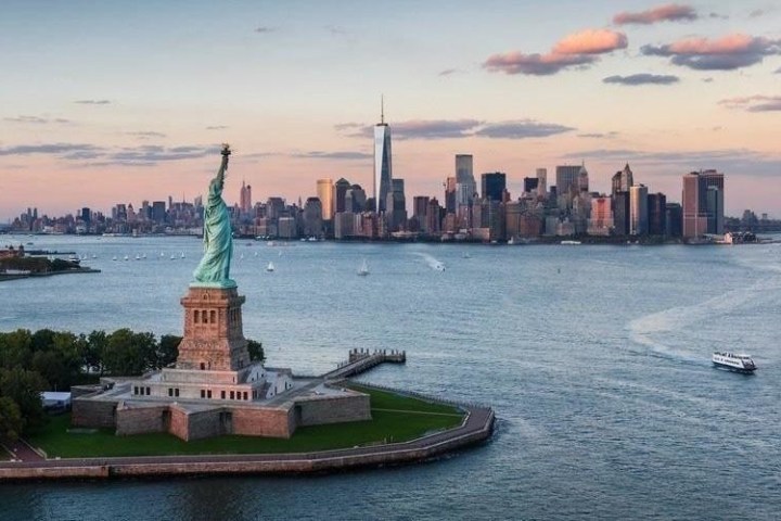 a small boat in a body of water with a city in the background
